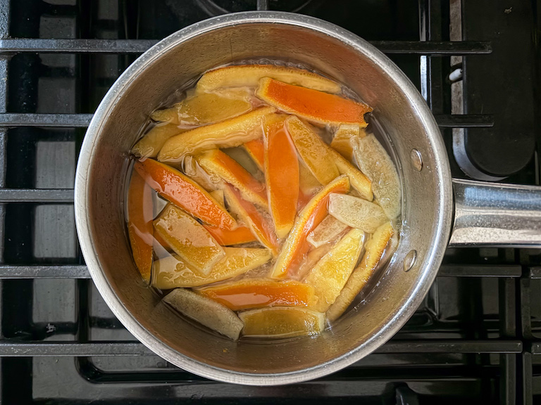 orange peels and water in a pan