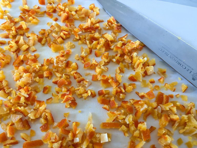 slicing candied mixed peel on a cutting board